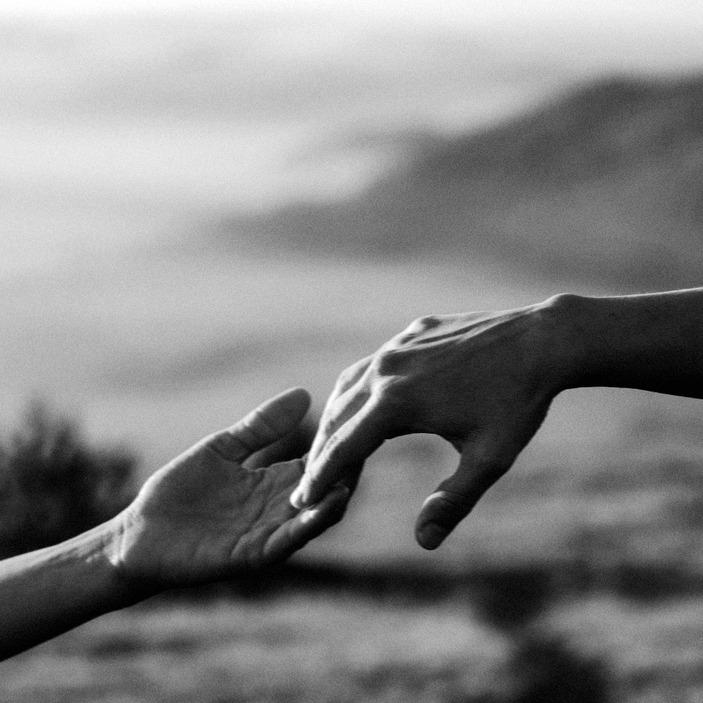Hands reaching towards each other in solidarity